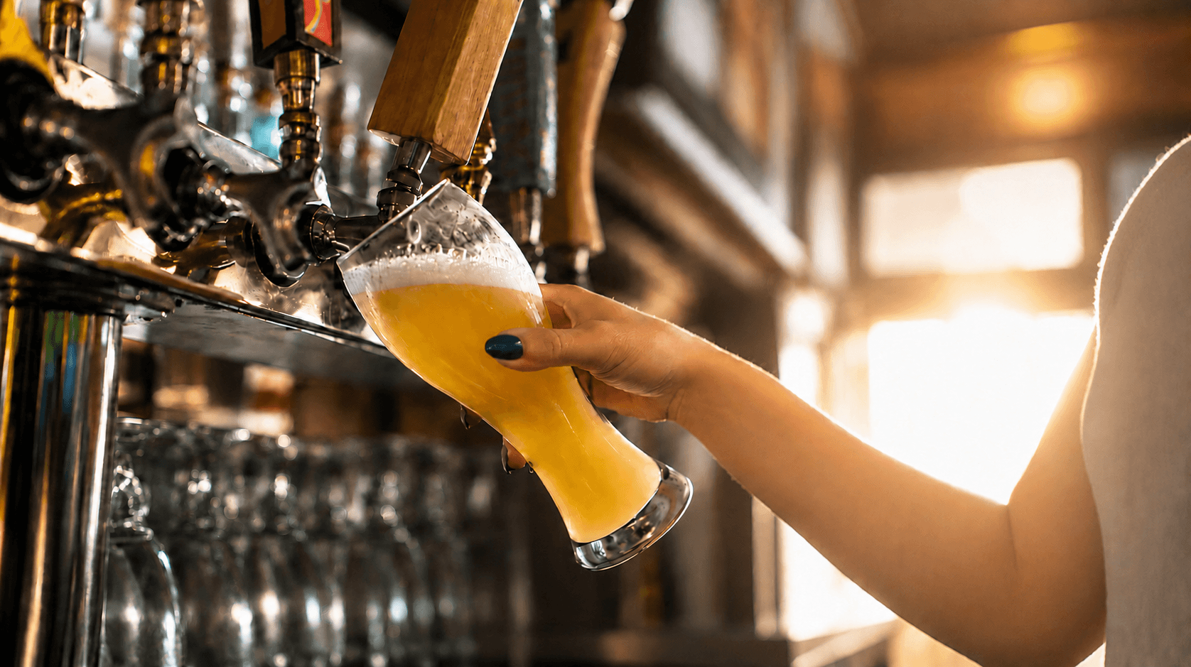 Close up of a bartender pouring a beer