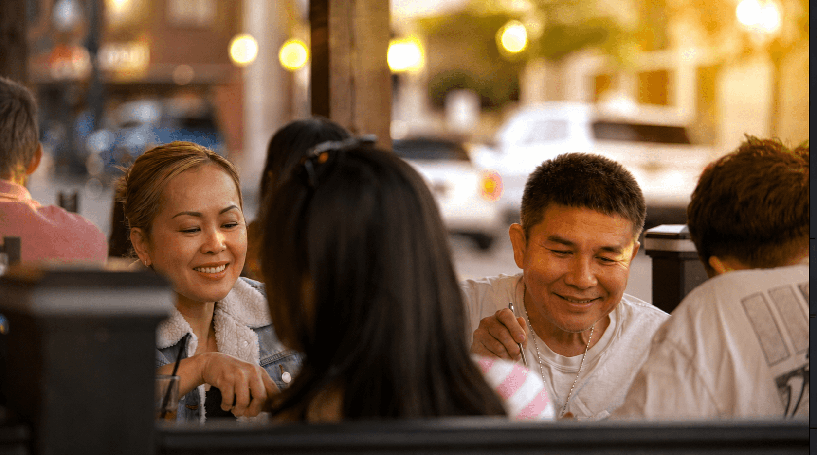 A family smiling on the patio