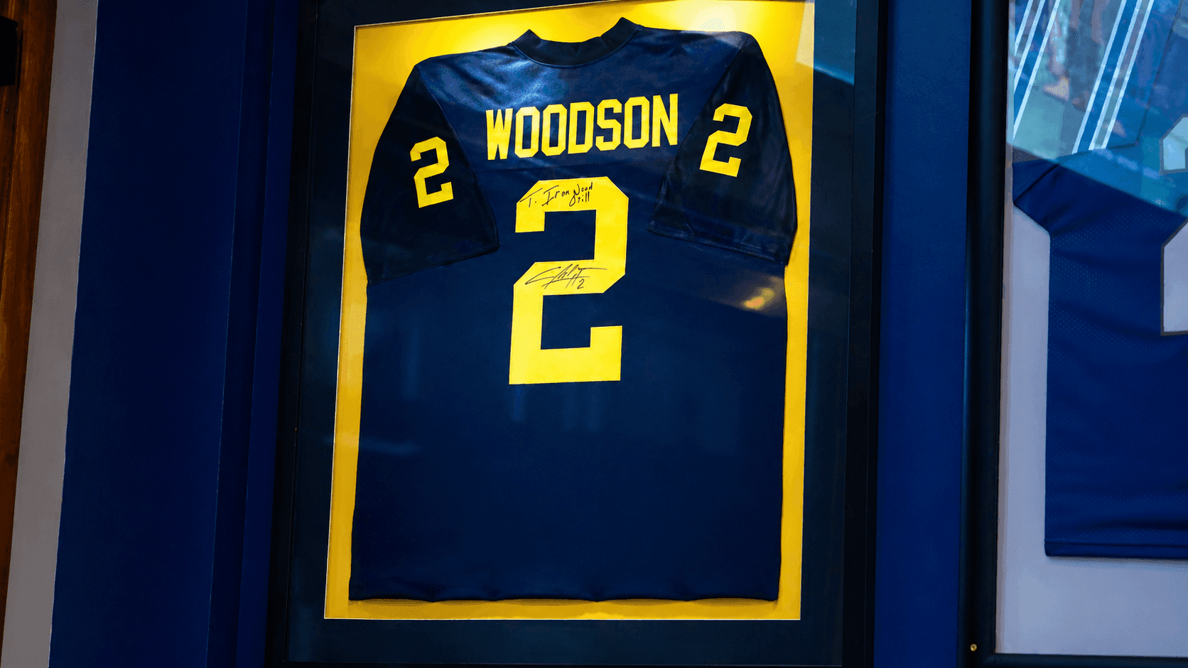 A University of Michigan jersey on the wall