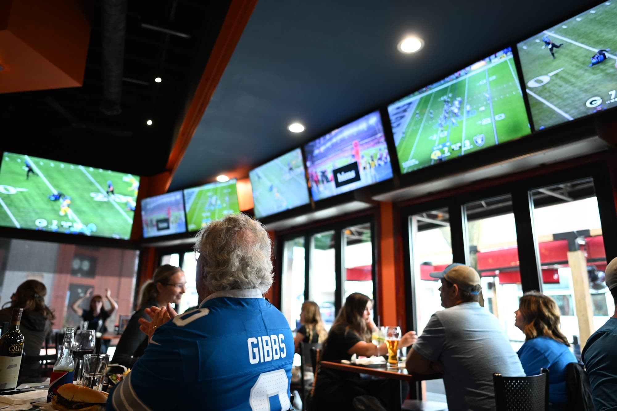 A Lions fan watching the game by the windows